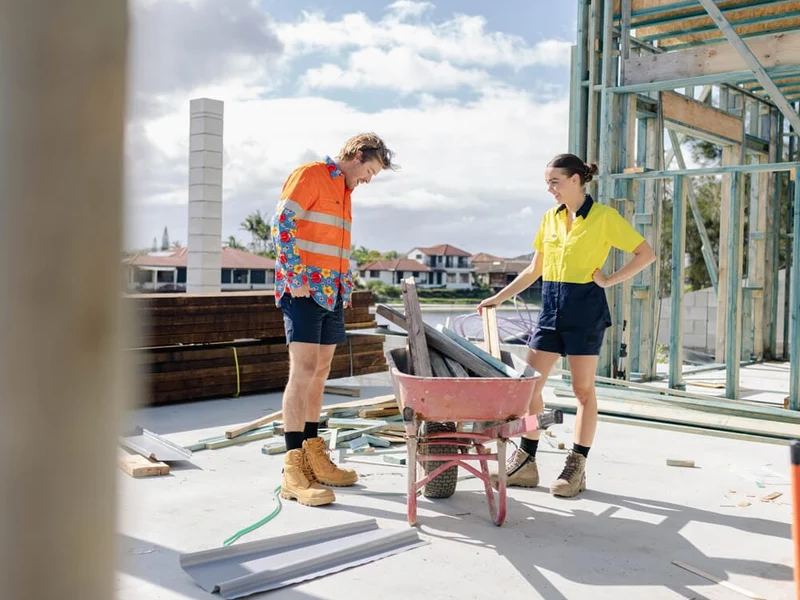 Two tradies in hi-vis on a residential build site